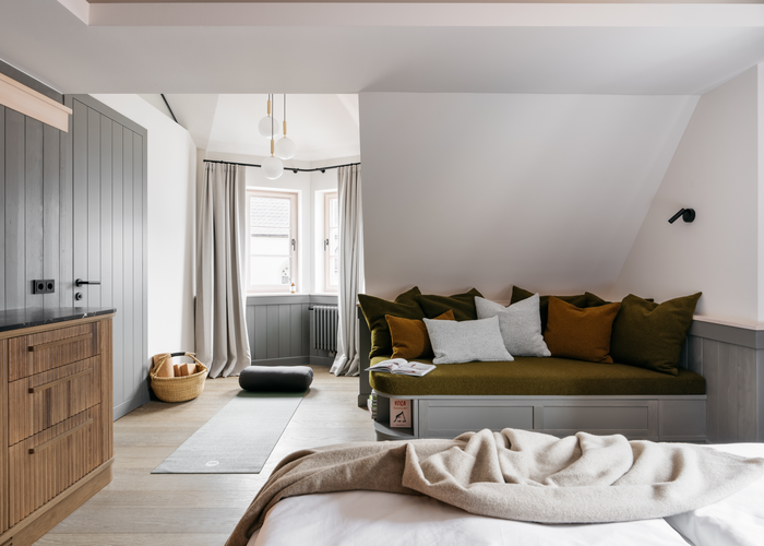 Die grau lackierten Türen und Wandvertäfelungen sowie die gebeizten Vollholzmöbel geben den Zimmern in den oberen Stockwerken eine heimelige Atmosphäre. | © Refugium Lunz / Gregor Hofbauer